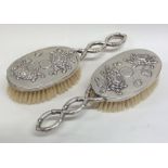 A pair of Chinese silver hair brushes with floral