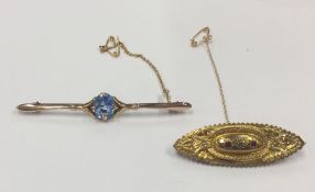 A gold and blue stone bar brooch together with one