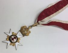 An enamelled medal in the form of a Maltese cross