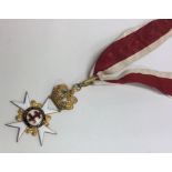 An enamelled medal in the form of a Maltese cross