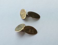 A pair of 9 carat oval cufflinks with engine turne