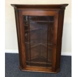 An oak corner cupboard with bevelled glass. Est. £