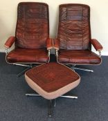 A pair of retro leather mounted swivel chairs toge