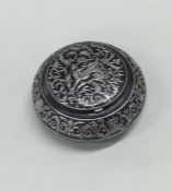 A circular silver inlaid and gun metal box. Approx