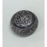 A circular silver inlaid and gun metal box. Approx