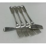 Five Georgian silver fiddle pattern table forks. L