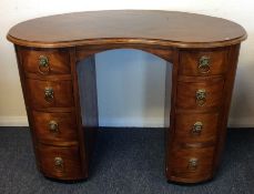 A Georgian mahogany kidney shaped eight drawer des