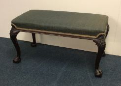 A Chippendale style upholstered mahogany stool wit