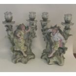 A pair of Continental porcelain candlesticks decor