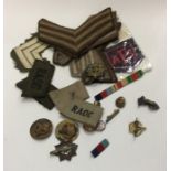 A collection of old Military badges and Service st