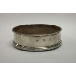 A modern silver wine coaster with beaded rim. Appr