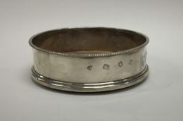 A modern silver wine coaster with beaded rim. Appr