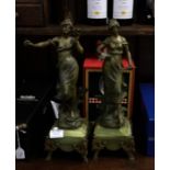 A pair of onyx and spelter figures with brass moun