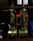 A pair of onyx and spelter figures with brass moun
