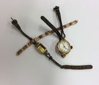 A small gold watch strap together with a gold watc