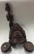 An unusual tribal mask together with a figure etc.