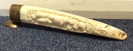 An Antique carved tusk with hippopotamus decoratio