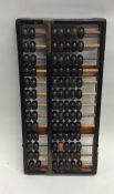 An old wooden abacus. Est. £20 - £30.