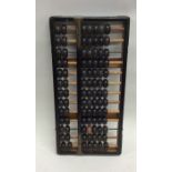 An old wooden abacus. Est. £20 - £30.