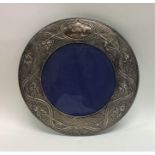 A large circular silver picture frame mounted with