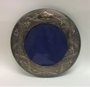 A large circular silver picture frame mounted with