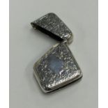 A silver hinged top vesta case with diagonal openi