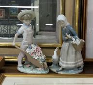 A large Lladro figure of a boy together with one o