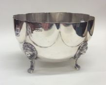 A large Edwardian silver bowl decorated on four ha