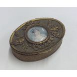 An attractive oval brass mounted snuff box with ov
