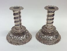 A pair of stylish embossed silver candlesticks dec