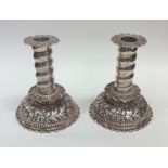 A pair of stylish embossed silver candlesticks dec