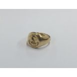 A small gold signet ring inset with crest. Approx.