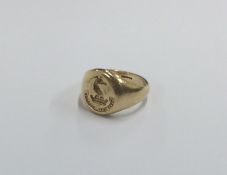 A small gold signet ring inset with crest. Approx.