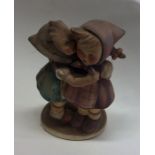 A Hummel figure of two children hugging. Est. £15