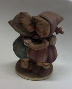 A Hummel figure of two children hugging. Est. £15