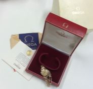 OMEGA: A lady's 9 carat wristwatch contained withi
