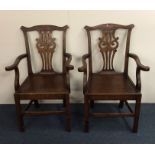 A pair of Georgian oak carver chairs on stretcher