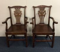 A pair of Georgian oak carver chairs on stretcher