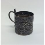 An Indian silver mug decorated with figures and an