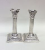 A good pair of Corinthian column silver candlestic