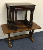 An oak nest of three tables together with an occas