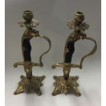 A pair of novelty brass mounted candlesticks in th