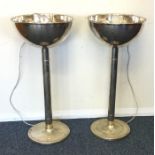 A pair of retro chrome lamps on spreading bases. A