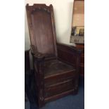 An unusual high back lambing chair with panelled s