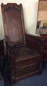 An unusual high back lambing chair with panelled s