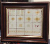 An attractively framed and glazed sampler together