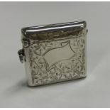 An Edwardian hinged top silver vesta case with flo
