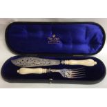 A pair of silver plated fish servers with turned i