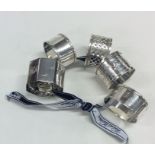 A collection of six silver napkin rings. Various d