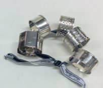 A collection of six silver napkin rings. Various d